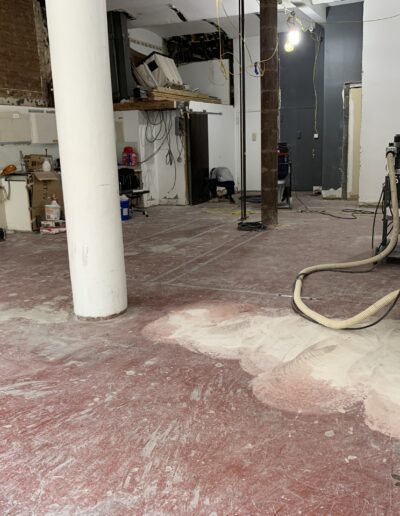 image shows a construction site, likely in the middle of floor work