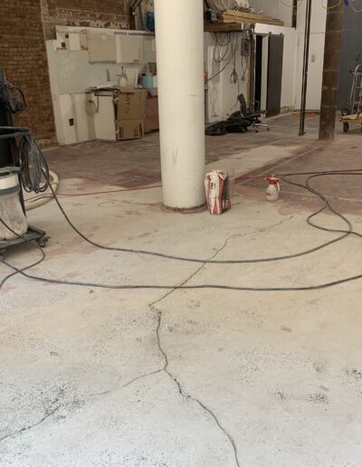 image shows a construction site, likely in the middle of floor work