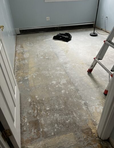 image of a room with a floor partially covered in vinyl plank flooring