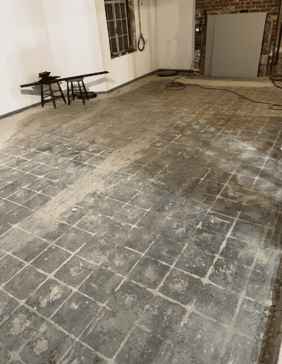 image shows a floor covered in linoleum tiles