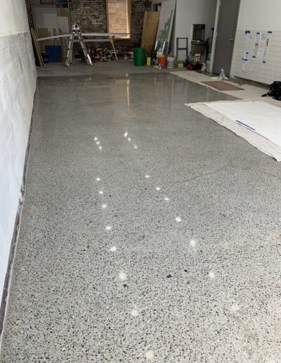 image shows a polished concrete floor in an industrial or commercial space