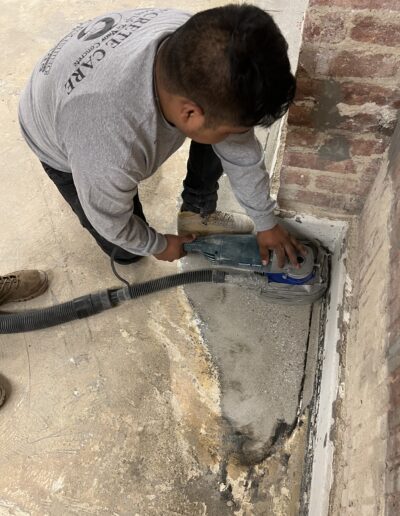 A man using a machine to fix a floor leakage