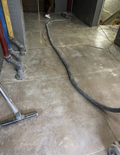 A man vacuuming a floor with a vacuum cleaner